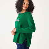 Green sweater with pink text 'Weekender' worn by a person on a white background