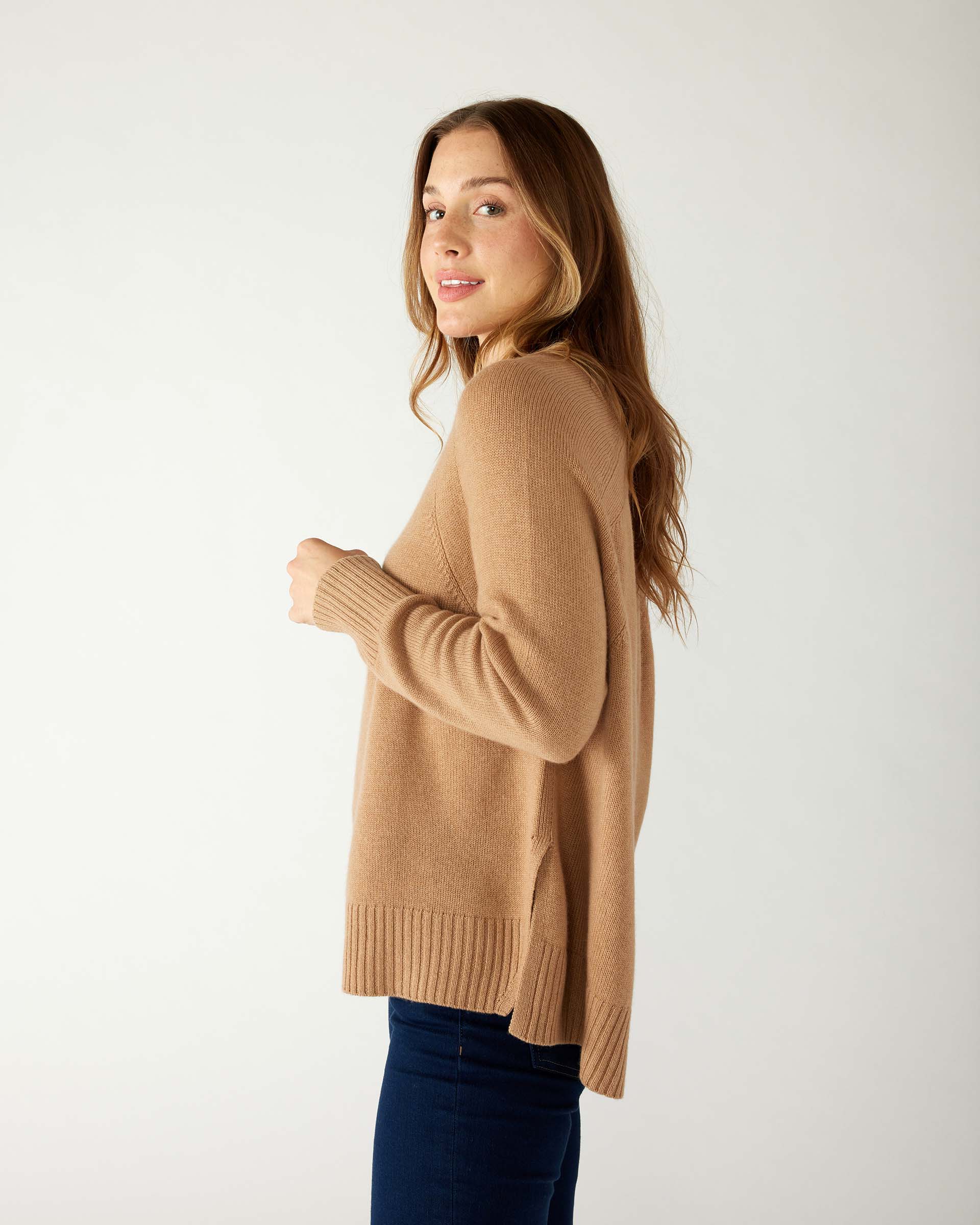 profile of woman wearing mersea banff cashmere sweater in camel