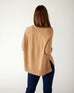 rear view of woman wearing mersea banff cashmere sweater in camel