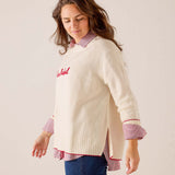 Cream knit oversized sweater with a red 'La Rebel' script graphic and side slits. Text: La Rebel
