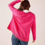 Back view of a vibrant pink knit sweater with ribbed hem and cuffs.