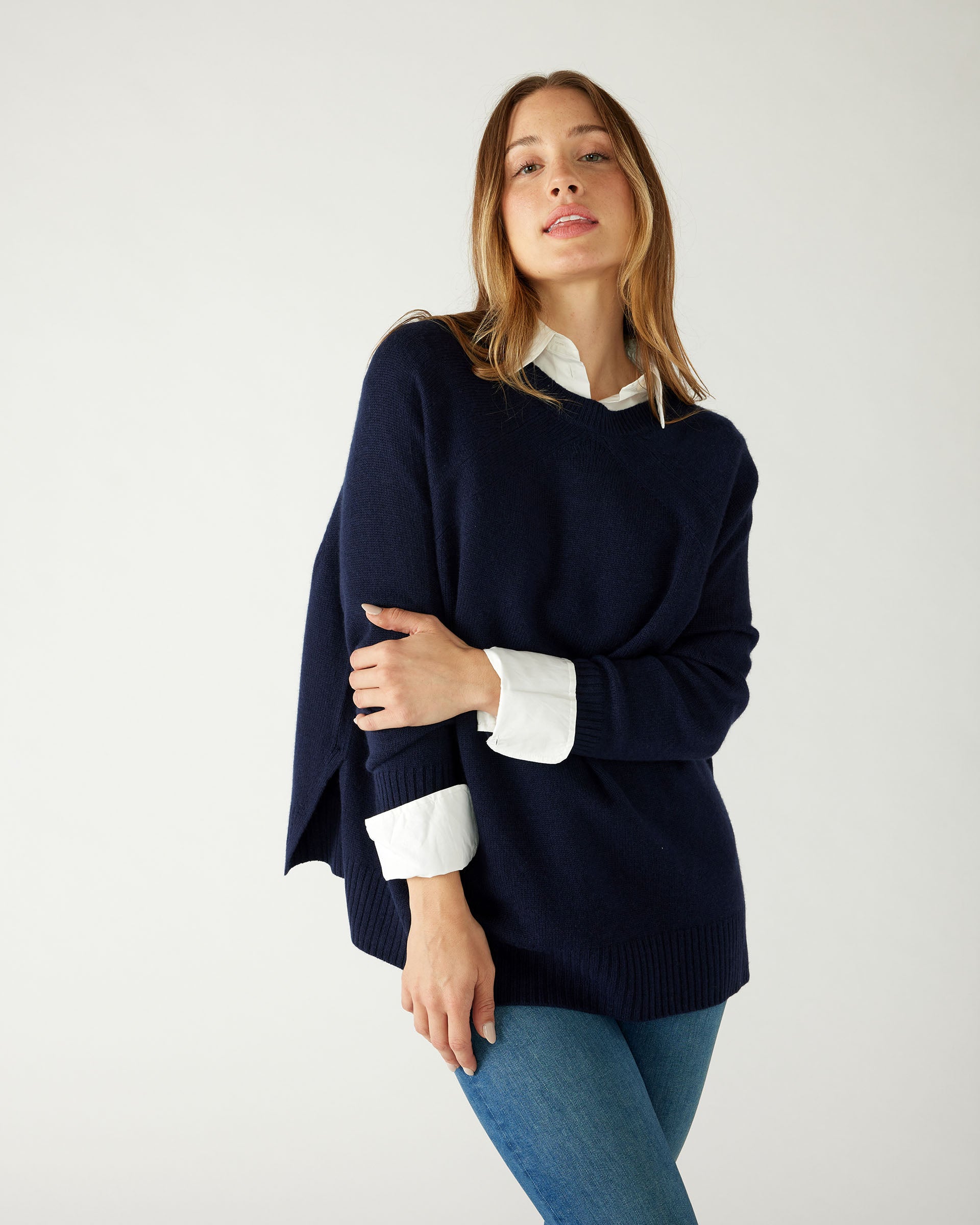 woman wearing mersea banff sweater in navy holding arm