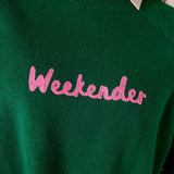 Forest green ribbed knit sweater with 'Weekenders' embroidered in pink. Text: Weekenders