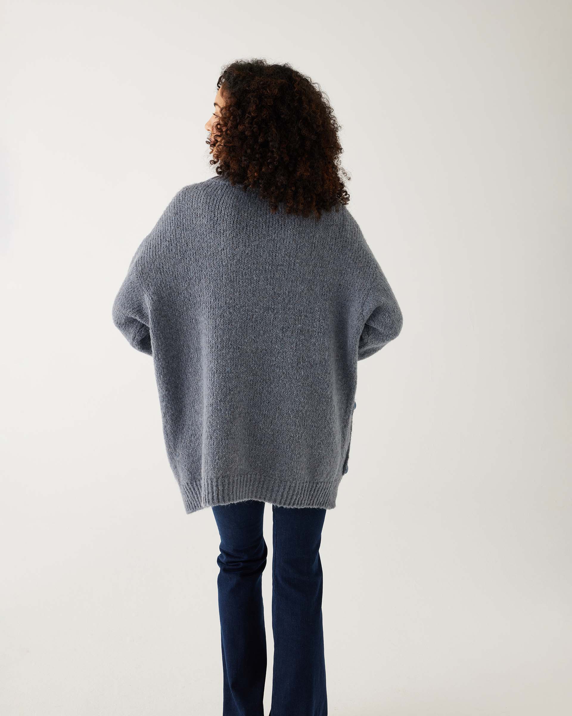 rearview of woman wearing mersea bari side button frost gray sweater standing against white background