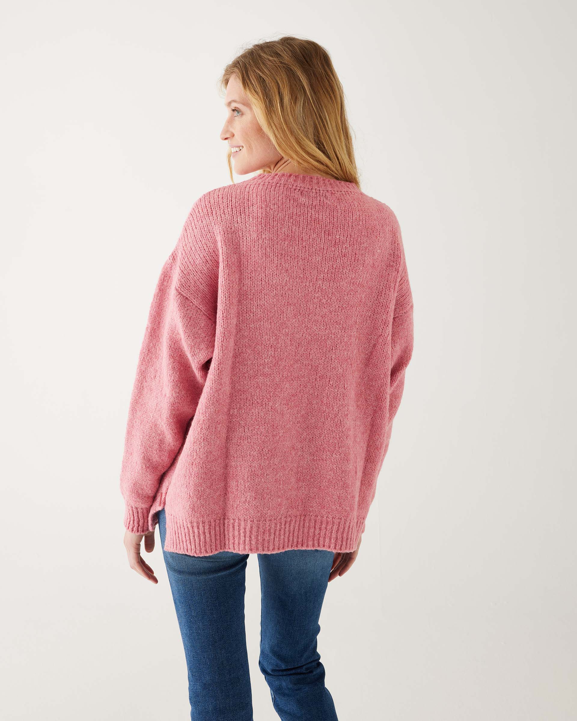 rearview of woman wearing mersea bari side button rouge sweater standing against white background