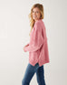 profile of woman wearing mersea bari side button rouge sweater standing against white background