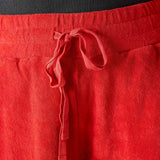 Close-up of red pants with a drawstring on a blurred background