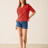 Ladies' travel-ready sunbaked terracotta knit beach club top with a V-neckline and short sleeves.
