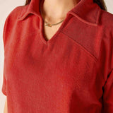Sunbaked terracotta-colored terry cloth top with a collar and V-neckline.