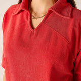 Red shirt worn by a person with a neutral background