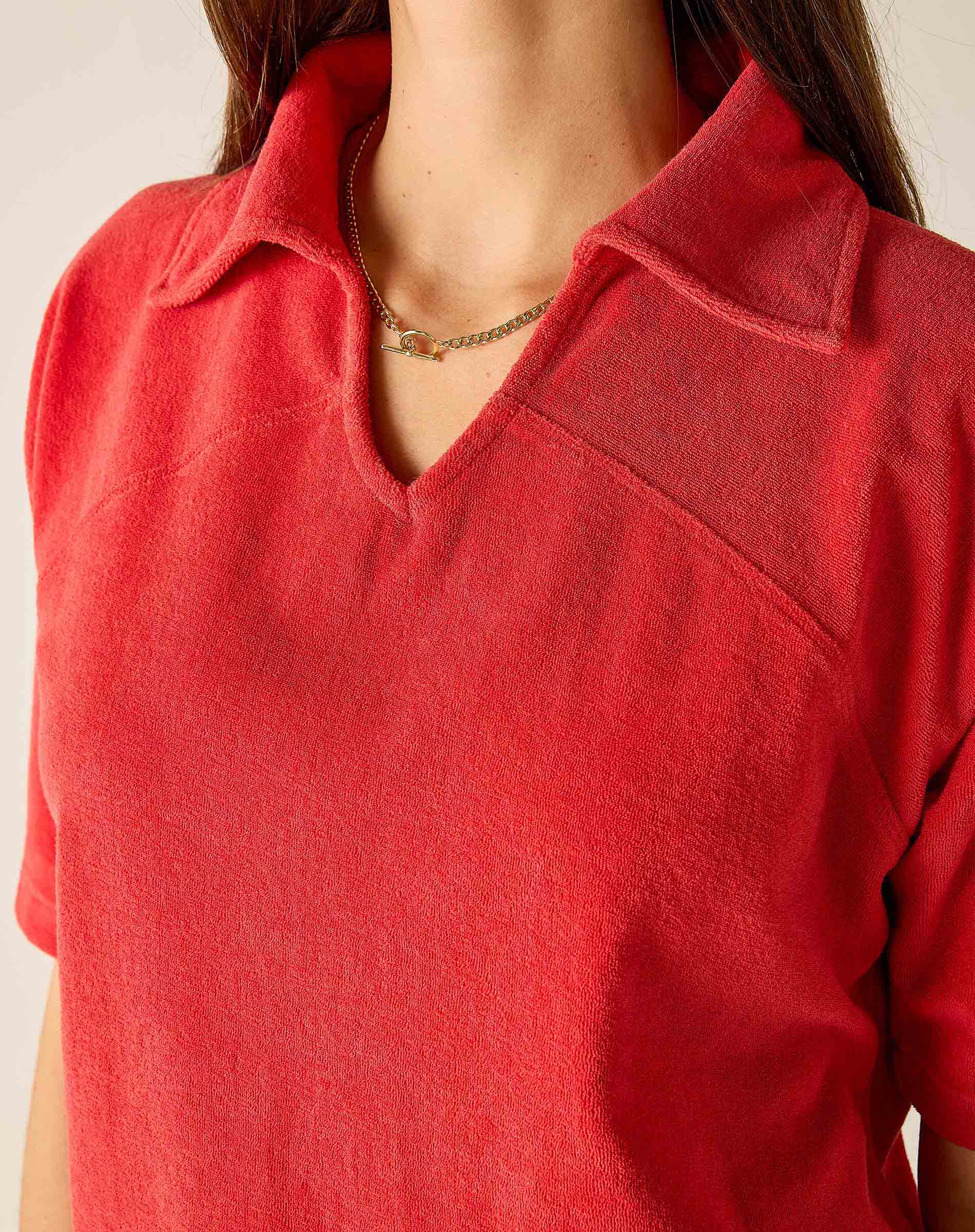 Red shirt worn by a person with a neutral background