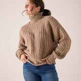 MERSEA ladies' travel-ready beachstone tan ribbed knit sweater with a turtleneck and balloon sleeves.