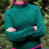 Ladies' travel-ready bright emerald green ribbed knit sweater with vibrant pink trim on the collar and cuffs.