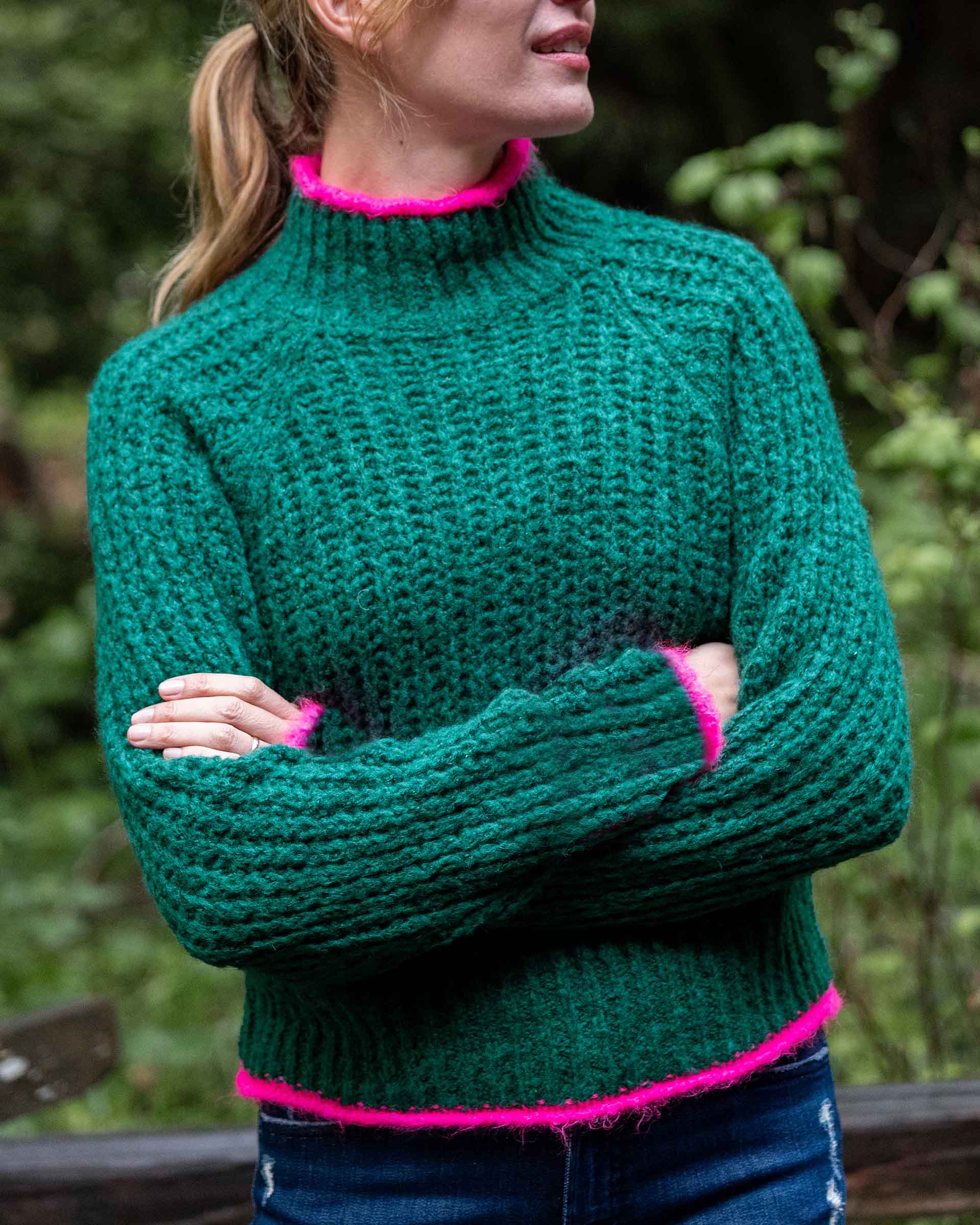 Ladies' travel-ready bright emerald green ribbed knit sweater with vibrant pink trim on the collar and cuffs.