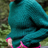 Bright emerald knit sweater with hot pink trim and ribbed texture.