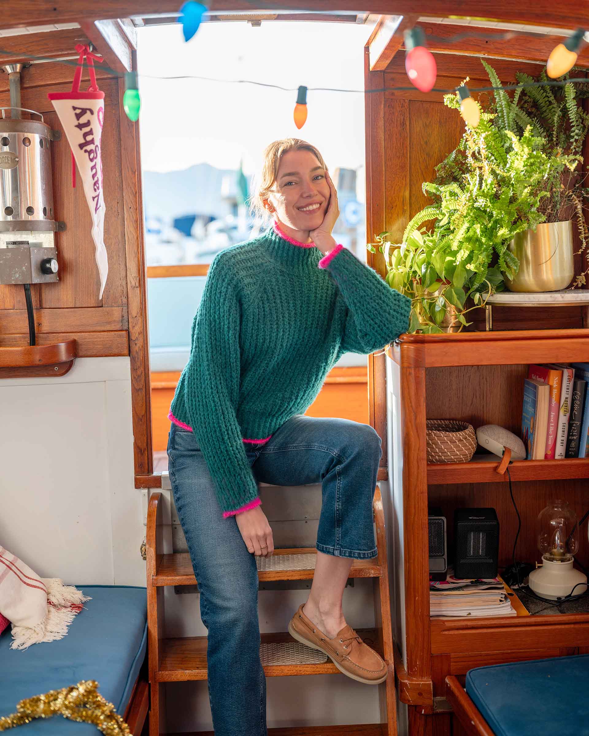 Emerald green textured knit sweater with pink trim and a ribbed hem.
