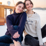 Ladies' travel-ready navy blue oversized knit sweater with ribbed details.