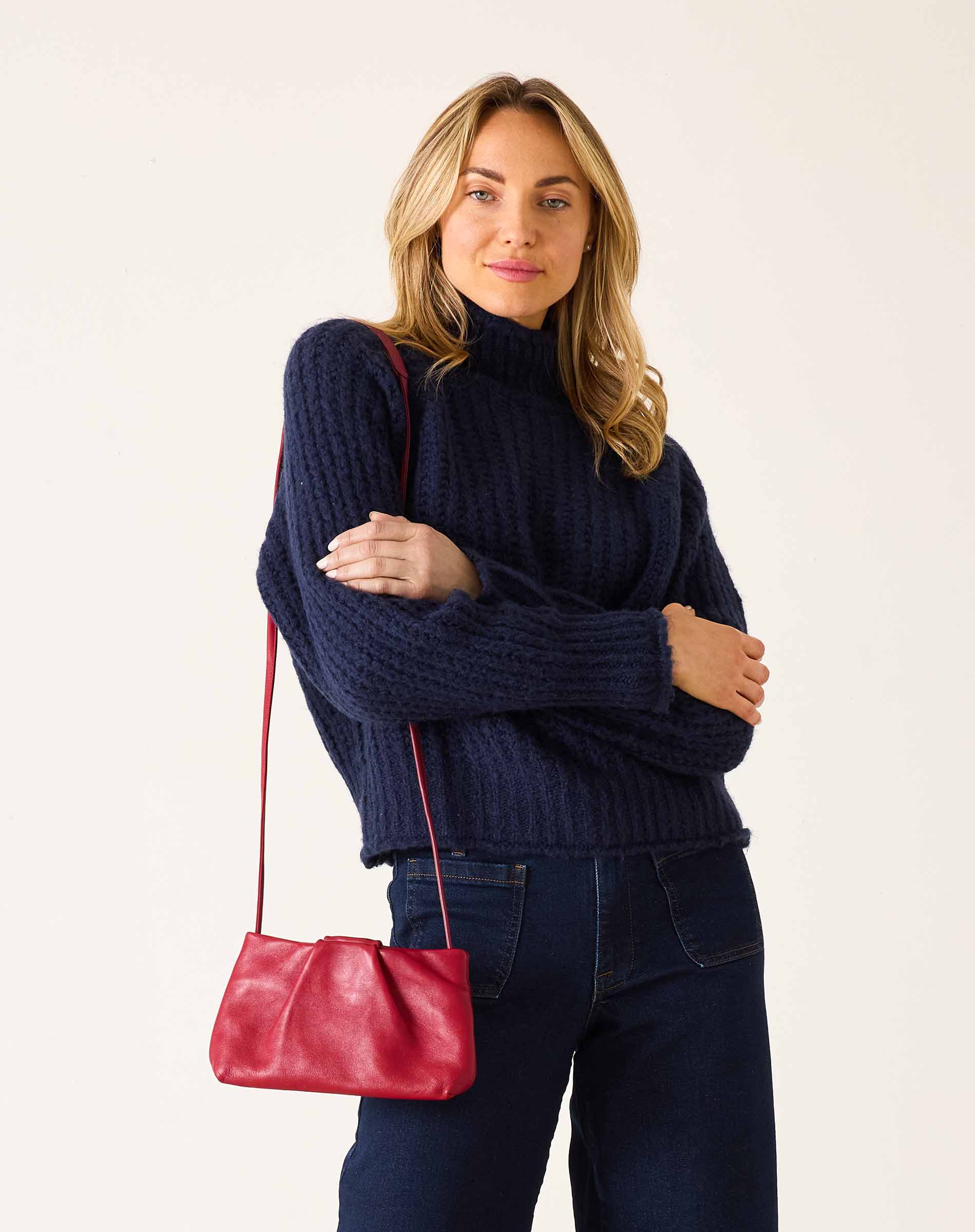 Navy blue oversized knit sweater with a high neckline and textured weave.