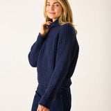 Navy blue ribbed knit sweater with a high turtleneck and long sleeves.