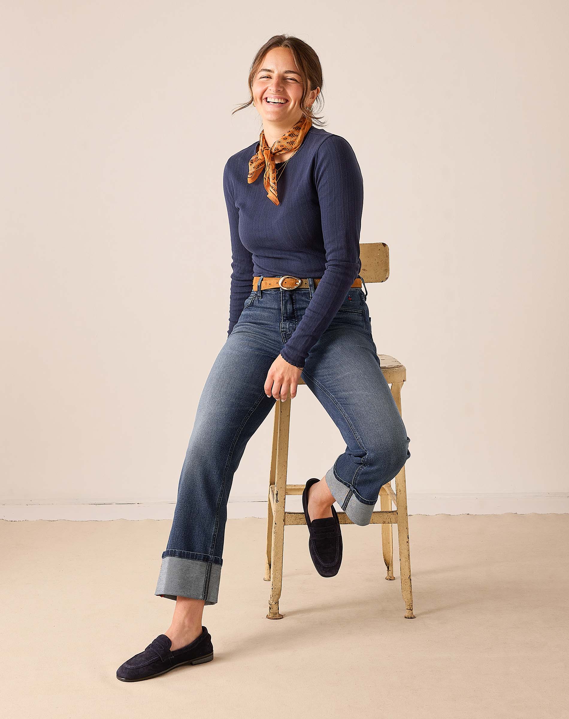 Women's travel-friendly faded indigo straight leg denim jeans with rolled hems.