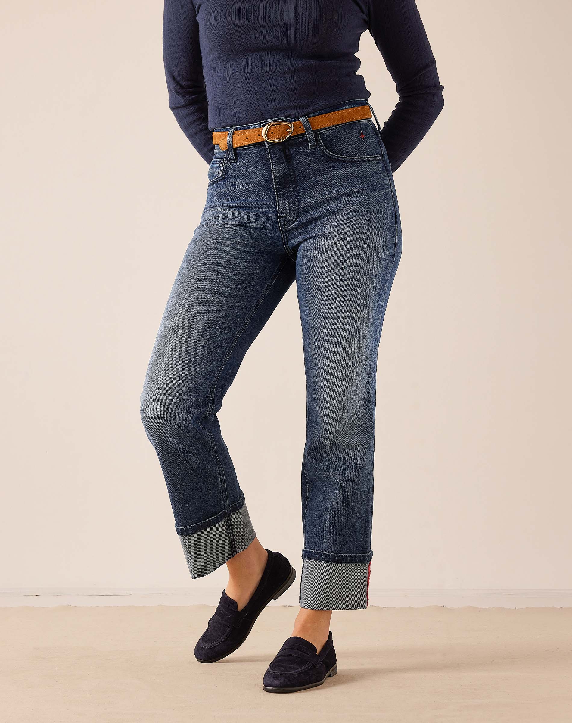 Faded indigo straight-leg denim pants with rolled cuffs.