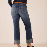 Faded indigo straight leg denim jeans with a cuffed hem and red stitching detail.