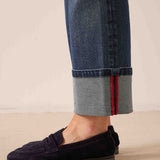 Faded indigo straight-leg denim pants with rolled cuffs and red stitching detail