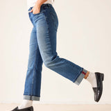 Faded ink straight leg denim jeans with a cuffed hem and distressed details.