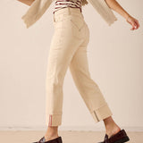 Oat colored straight leg pants in a soft cotton blend with contrast stitching and decorative hem details.