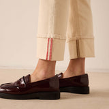 Oat-colored straight leg pants with a decorative cuff and seam detail