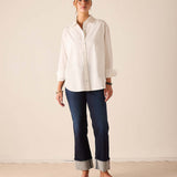 Women's travel-friendly navy blue rinse denim straight-leg pants with cuffed hems.