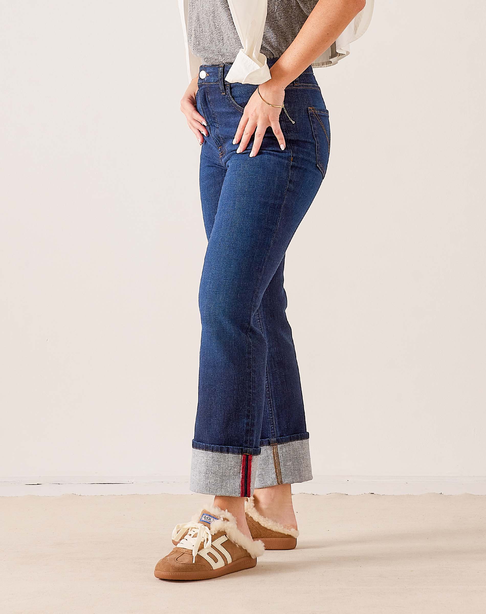 Dark wash denim straight-leg jeans with a contrasting grey and red stitched hem.