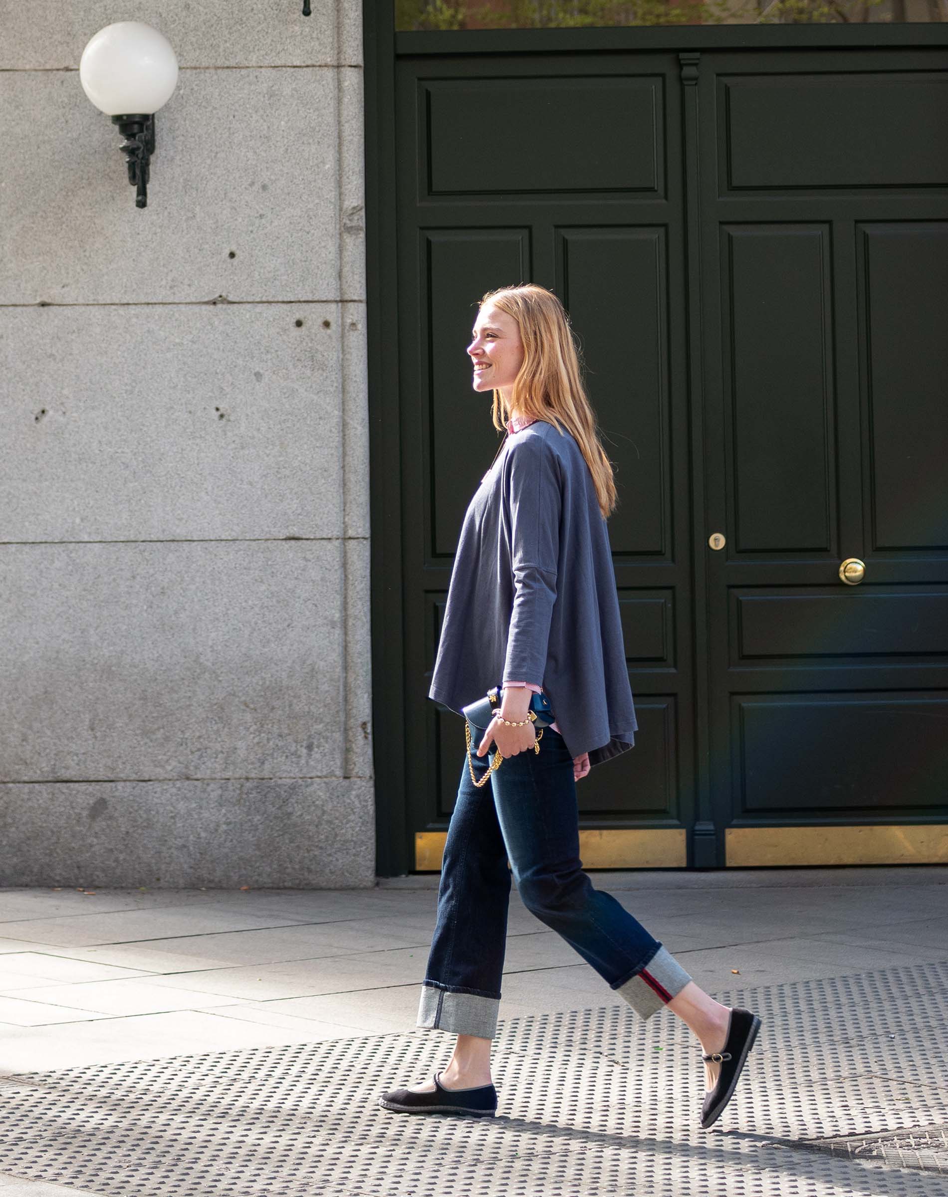 Charcoal grey oversized knit top and navy blue straight-leg pants with textured hems.