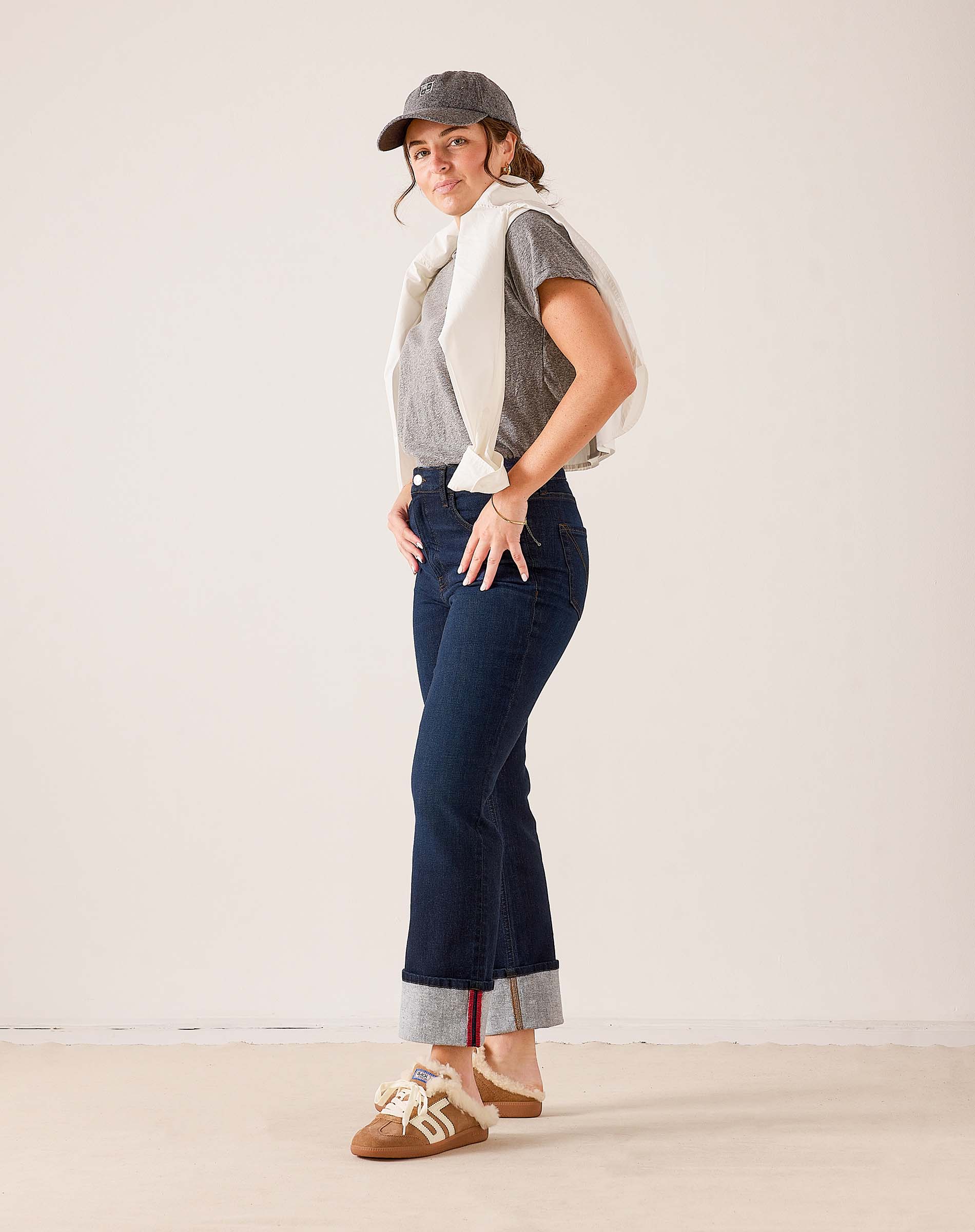 Dark wash denim Bessie straight-leg jeans with contrast hem and oversized white knit wrap.