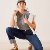Dark wash denim Bessie straight-leg jeans with rolled cuffs and a cream-colored cotton knit t-shirt.