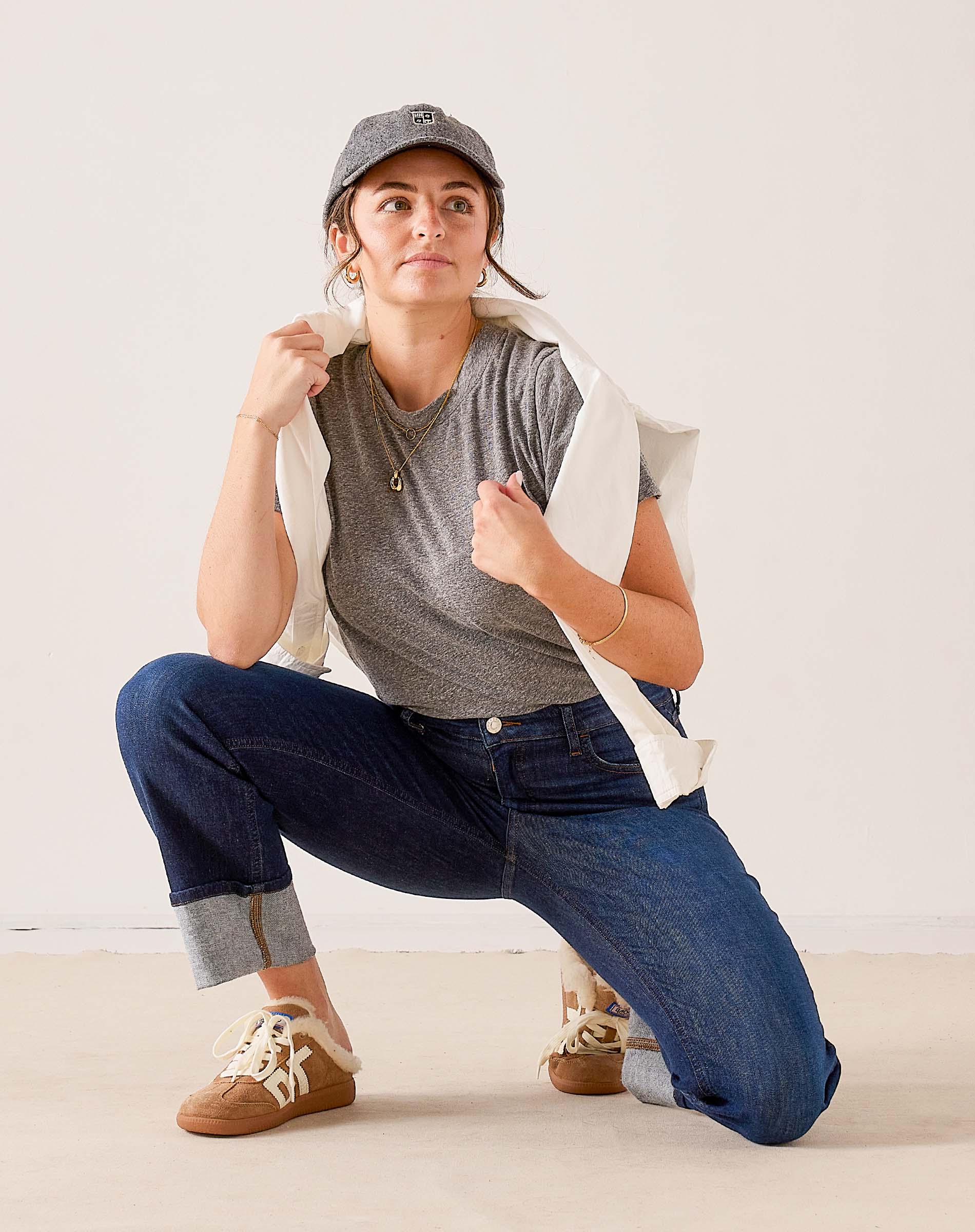 Dark wash denim Bessie straight-leg jeans with rolled cuffs and a cream-colored cotton knit t-shirt.
