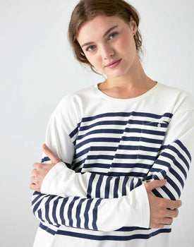 woman wearing mersea boater long sleeve tee in navy stripe with arms crossed