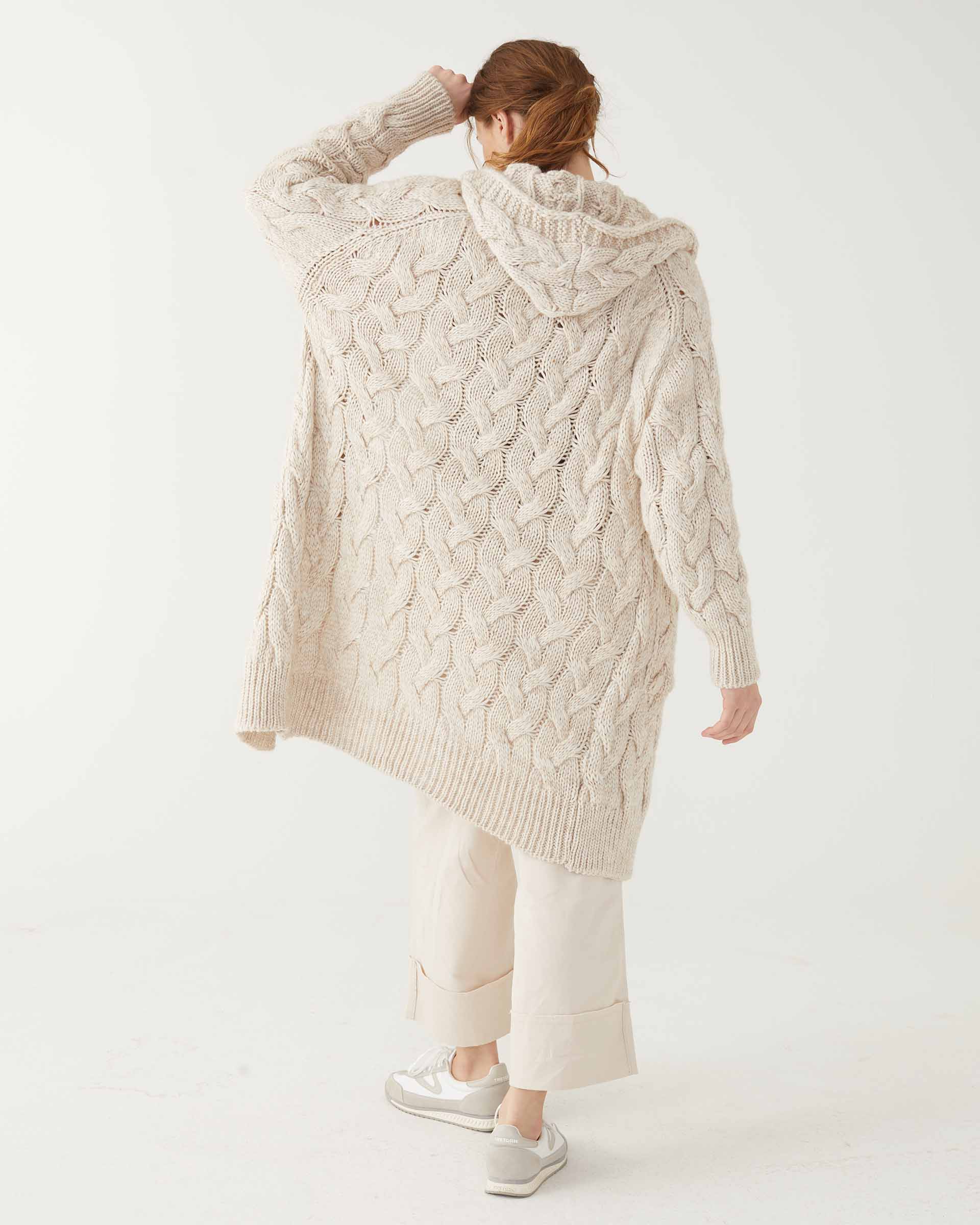 Rear view of Woman wearing Mersea Bonfire Hooded Duster with left arm raised