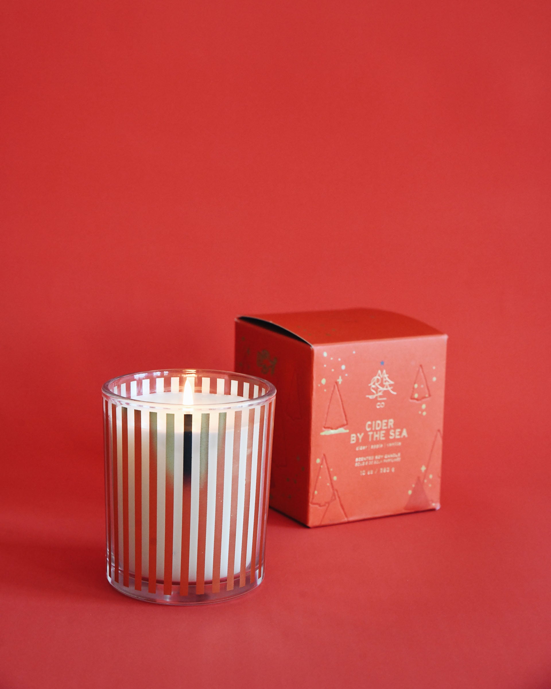 lit mersea cider by the sea holiday boxed candle next to candle box