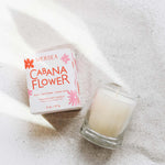 cabana flower votive candle laying in sand