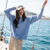 Ocean blue knit raglan sweater with a ribbed hem and cuffs.