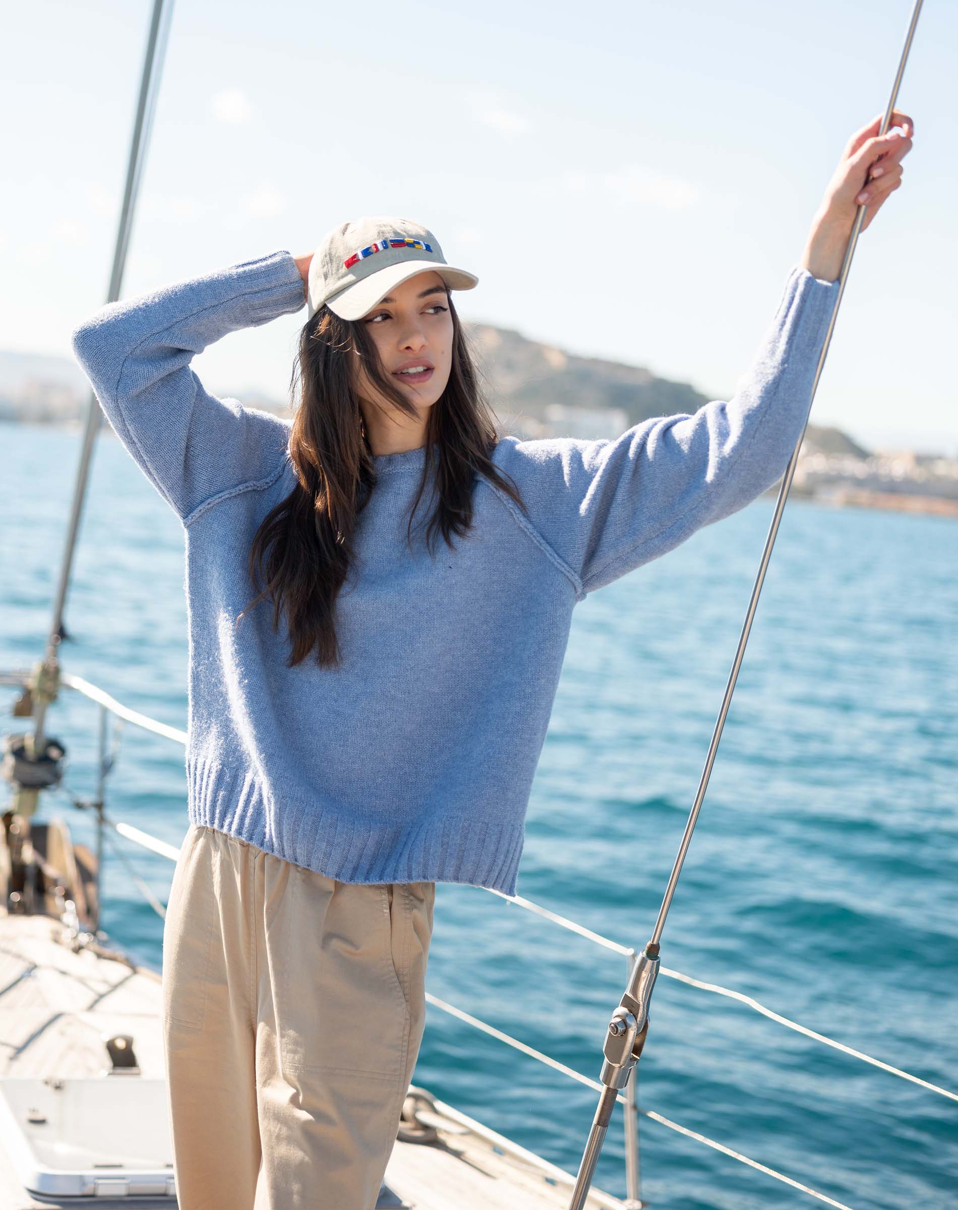 Ocean blue knit raglan sweater with a ribbed hem and cuffs.