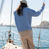 Ocean blue raglan knit sweater with a ribbed hem and sleeves.