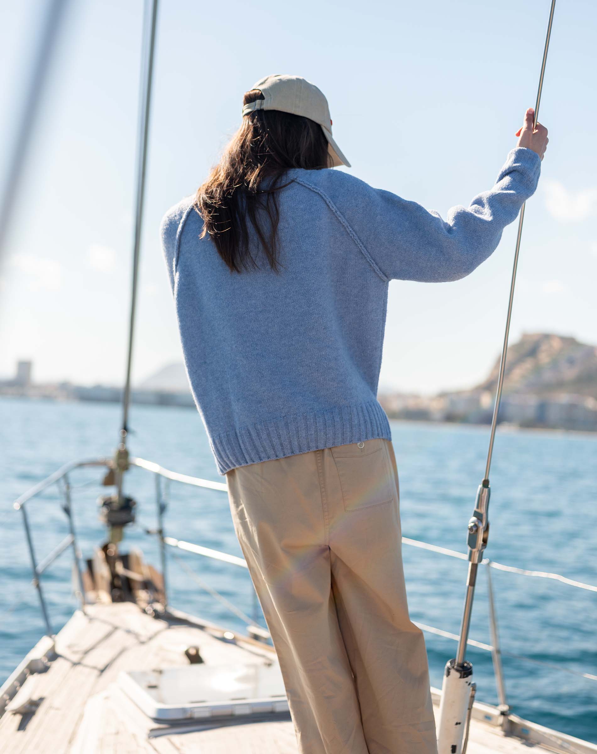 Ocean blue raglan knit sweater with a ribbed hem and sleeves.