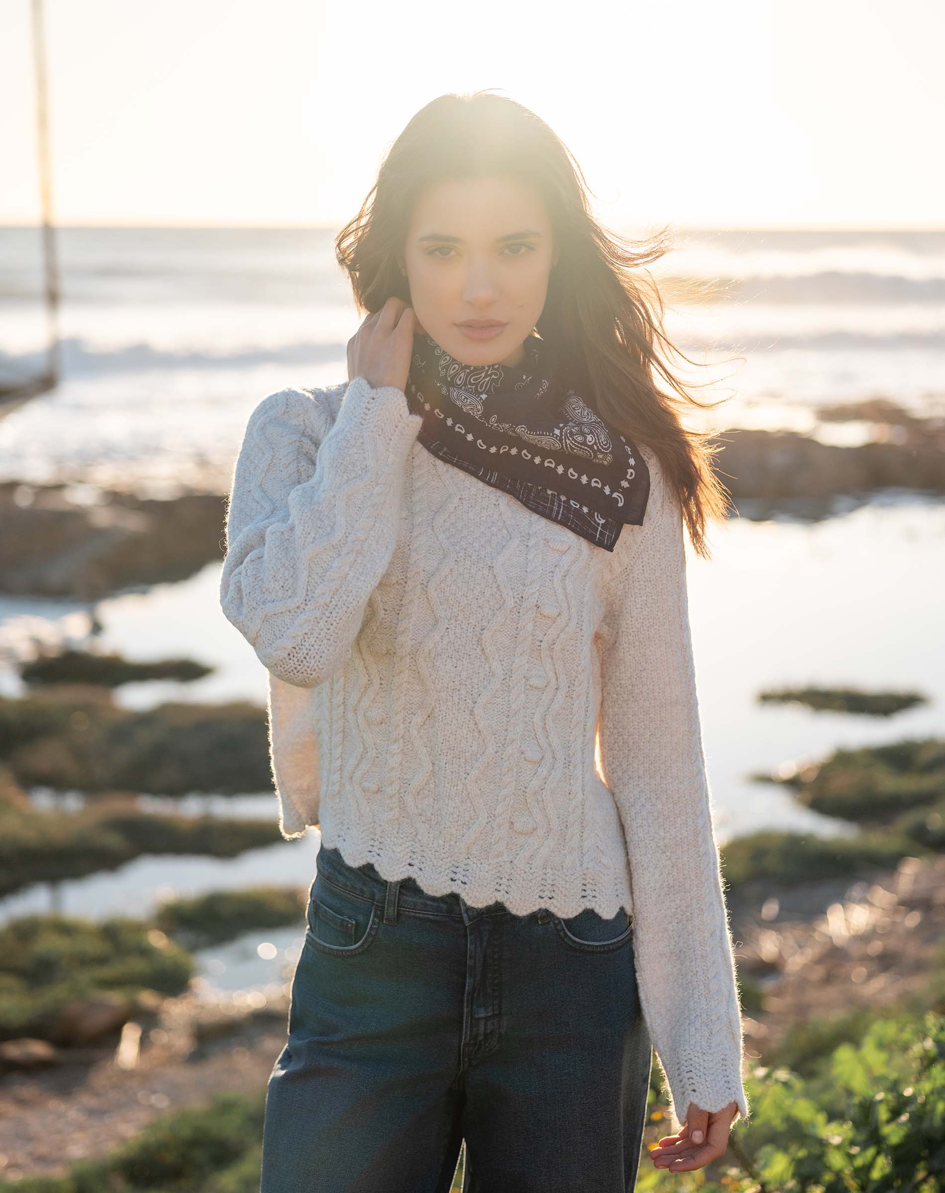 Cream cable-knit chunky knit sweater featuring a detailed textured pattern.