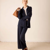 Ladies' travel-ready navy boyfriend jacket in a relaxed fit and smooth fabric.