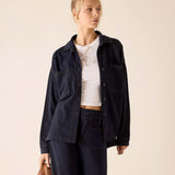 Navy blue relaxed fit cotton boyfriend jacket with button front and chest pockets.