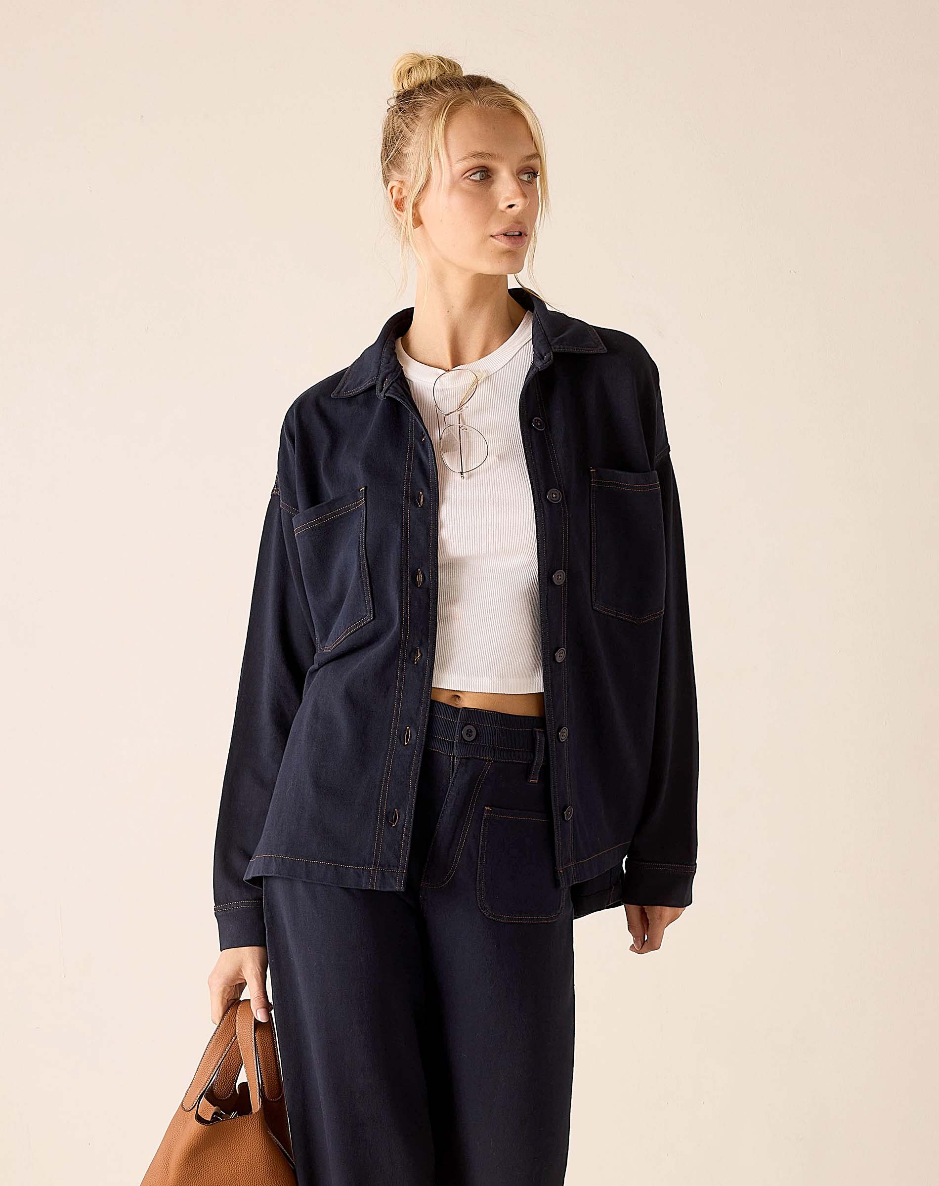 Navy blue relaxed fit cotton boyfriend jacket with button front and chest pockets.