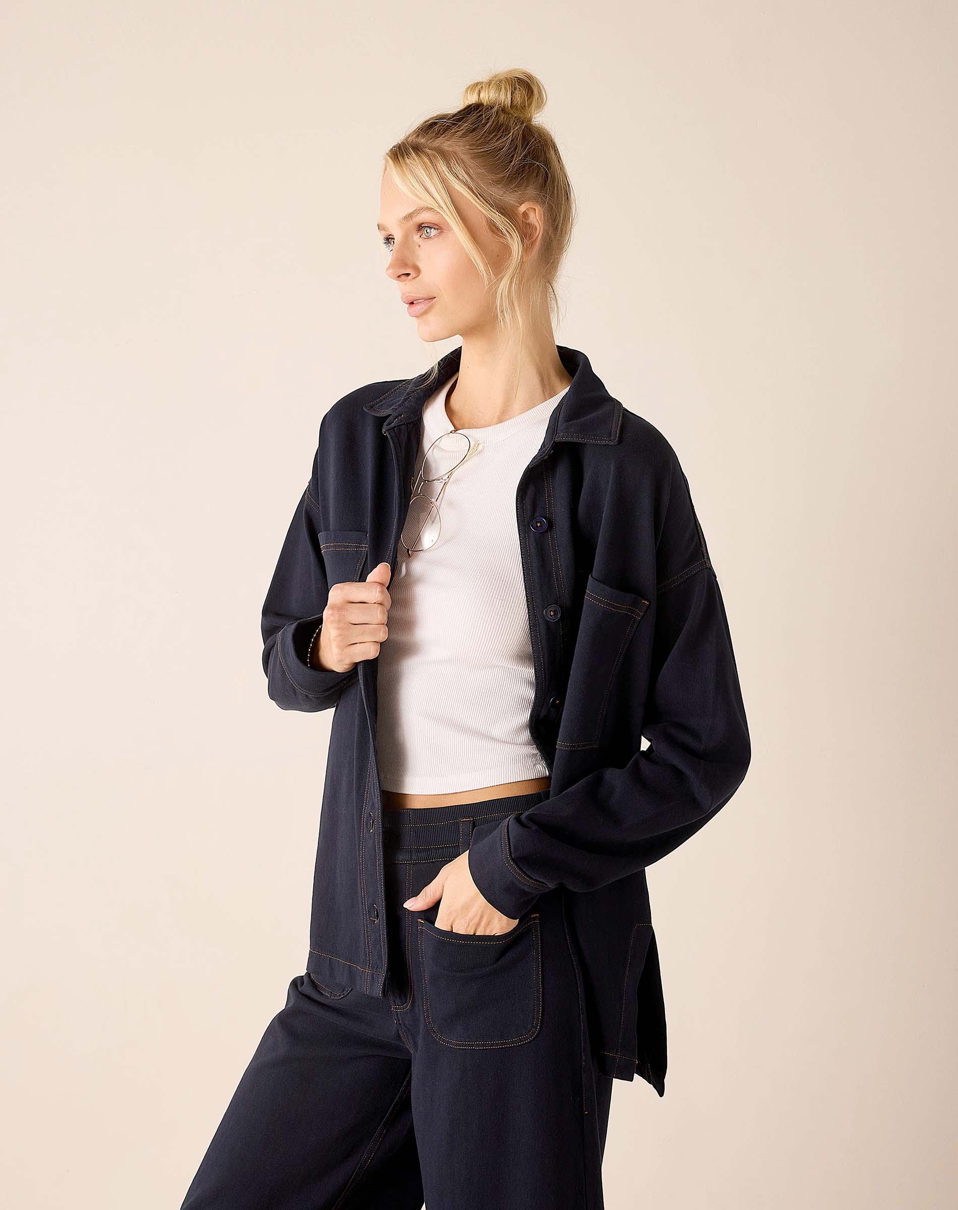 Navy blue oversized boyfriend jacket in soft cotton blend with front pockets.