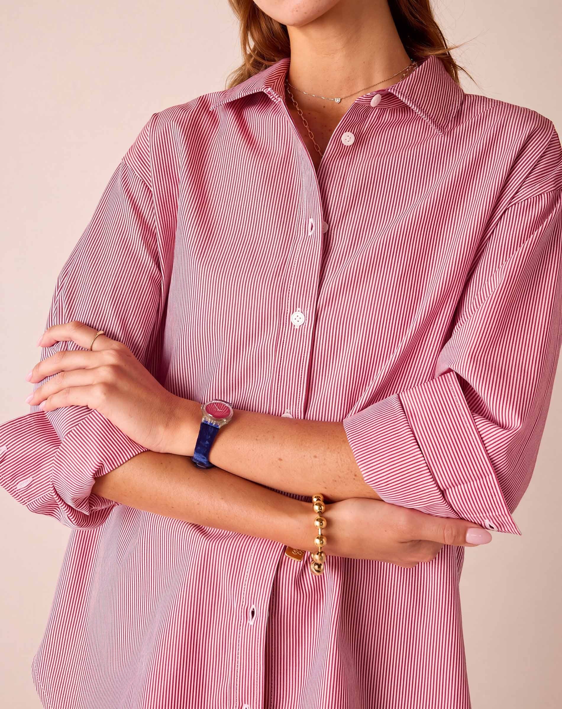 Cardinal red and white pinstripe button-up shirt featuring a relaxed fit and long sleeves with rolled cuffs.